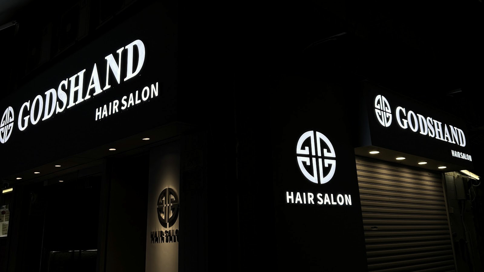 Godshand Hair Salon illuminated shopfront on Heung Wo Street, Tsuen Wan, at night